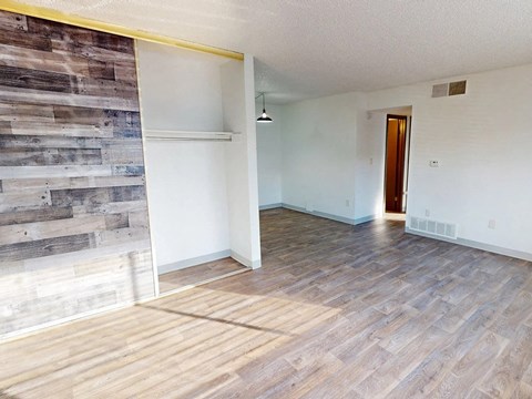 a living room with a wood syle floor and a sliding glass door