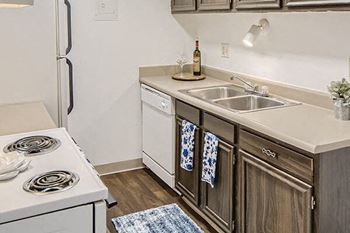 a kitchen with a sink stove and refrigerator