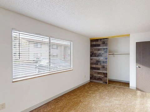 a living room with a large window and a door to a closet