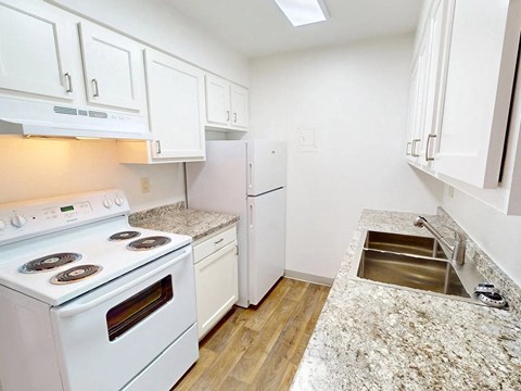 a kitchen with white appliances and white cabinets