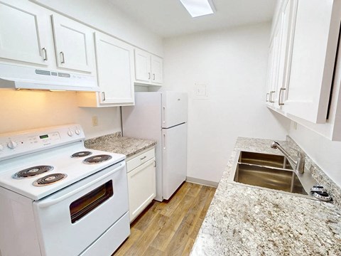 a kitchen with white appliances and white cabinets