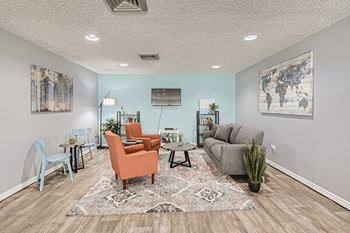 a living room with couches chairs and a tv