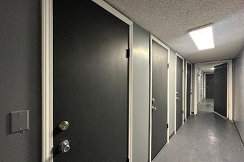 A long hallway with storage units for resident use