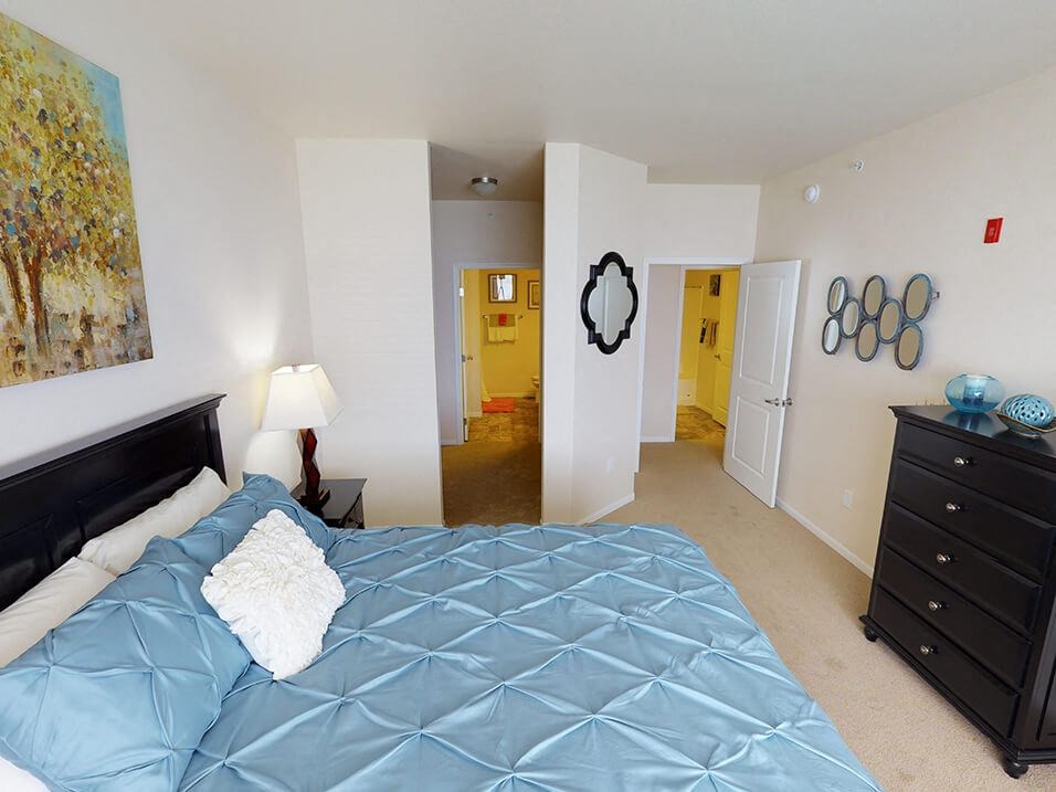 a bedroom with a large bed and a dresser