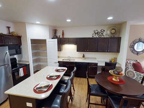 a kitchen with a table and chairs