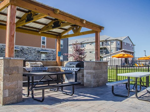 a patio with a grill and picnic table at the villas at falling waters in west om