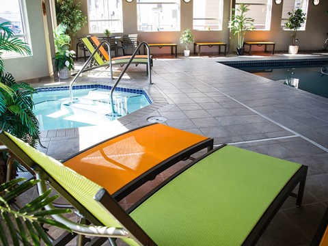 a pool area with lounge chairs and a plunge pool