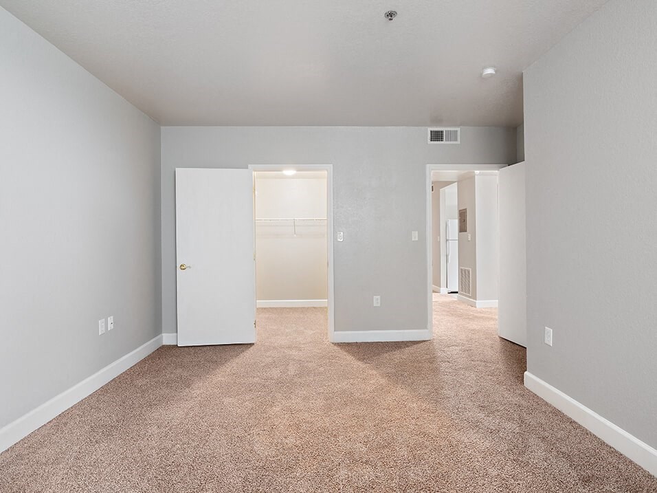 a bedroom with a carpeted floor
