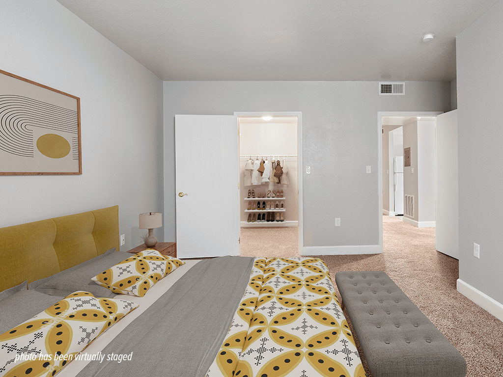 A bedroom with a bed and a painting on the wall.