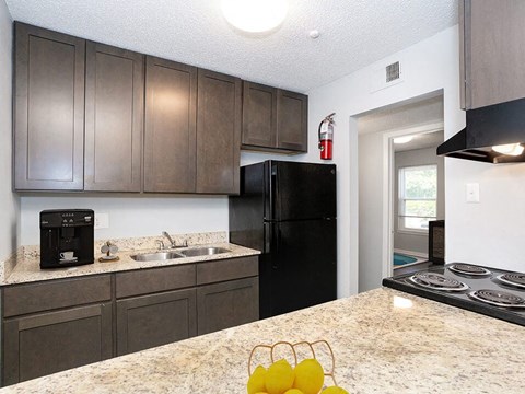 a kitchen with black appliances and a counter top