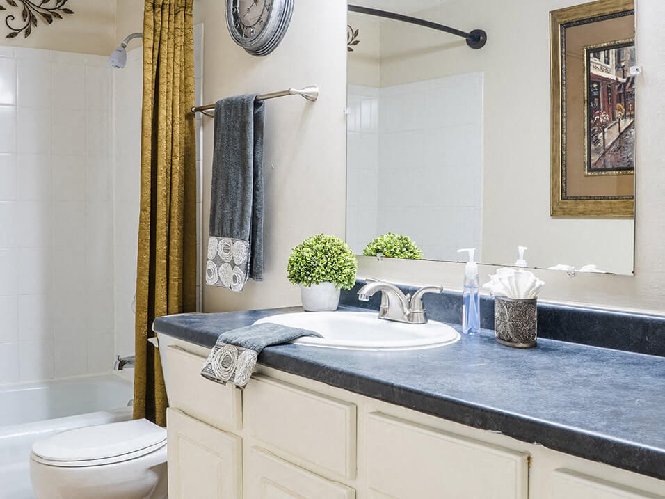apartment bathroom with a toilet, sink, and bathtub