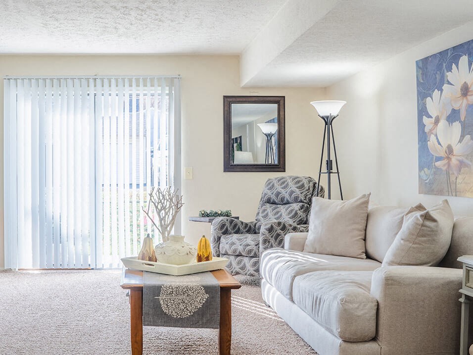 apartment living room with sliding glass door to patio