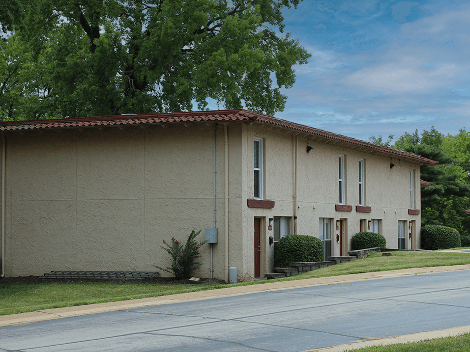 a white building with a red tile roof