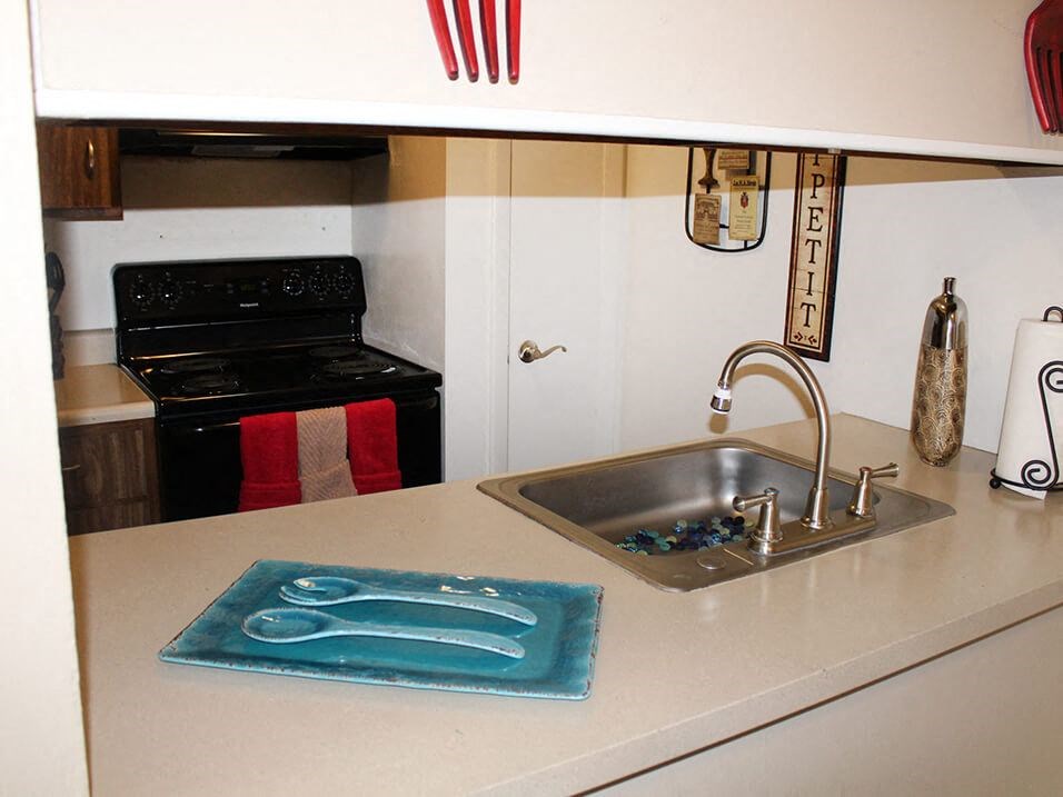 a kitchen with a sink and a stove