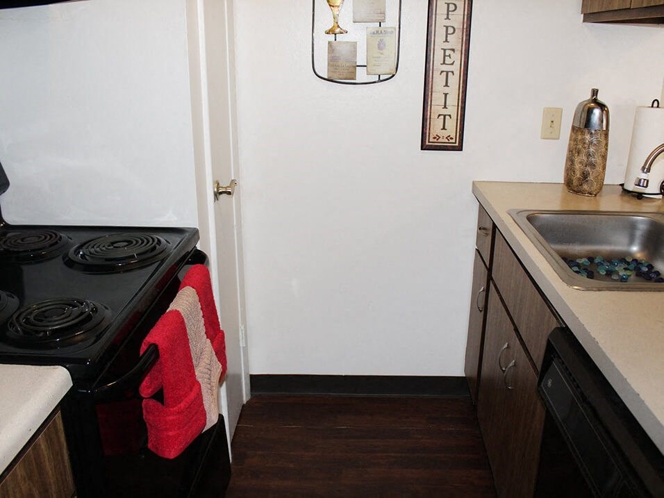 kitchen with a stove, refrigerator, and sink