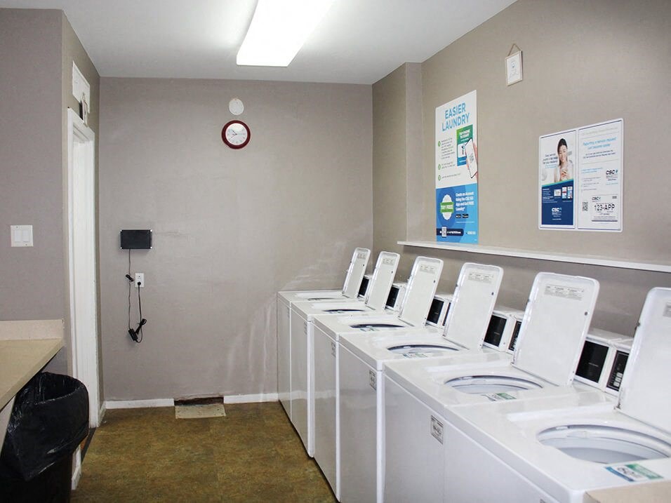 a laundry room with white washers