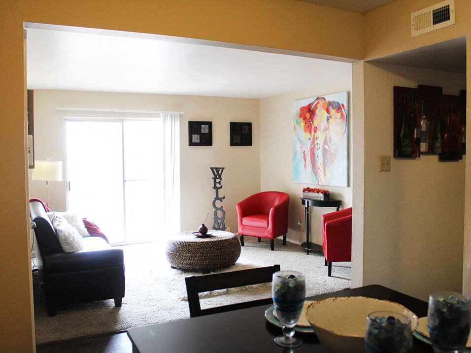 a living room with a couch chairs and a table