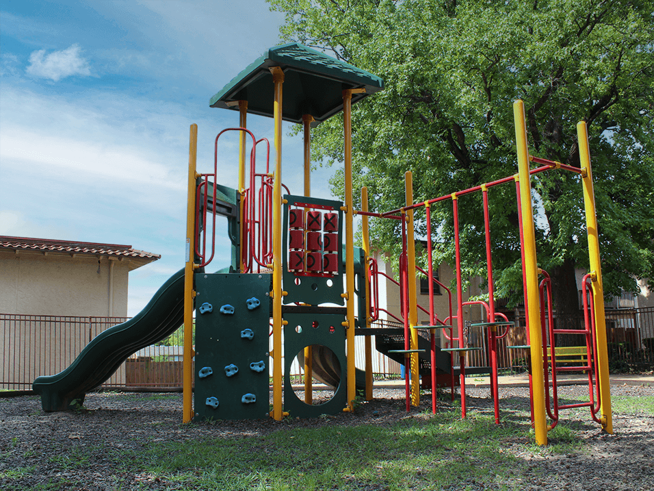 a playground with a slide and climbers