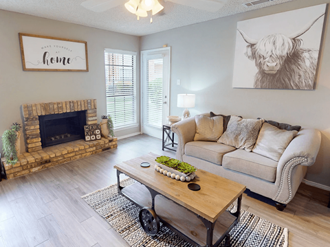 A living room with a fireplace and a couch.