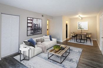 A living room with a white couch and a coffee table.