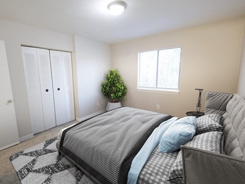 A bedroom with a large bed and a potted plant.
