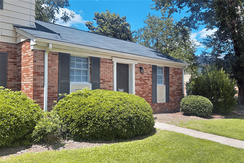 A house with a grey roof and a white garage door.