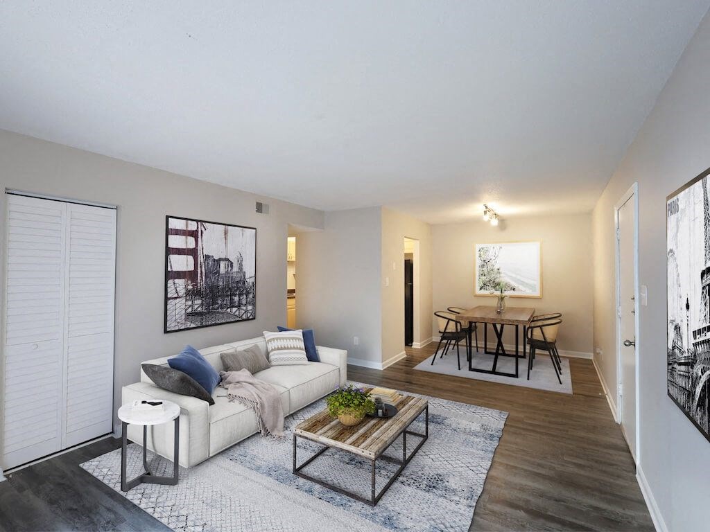 A living room with a white couch and a coffee table.