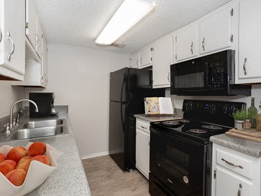 apartment with black kitchen appliances