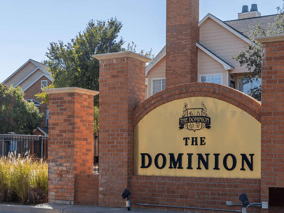 The Dominion Apartments sign in Lubbock TX