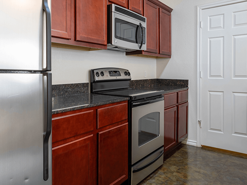 a kitchen with stainless steel appliances and wooden cabinets