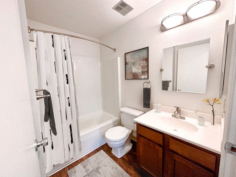 a bathroom with a sink toilet and shower