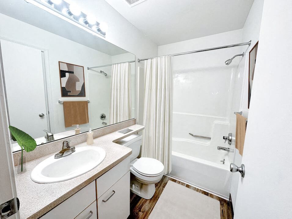 a bathroom with a sink toilet and shower