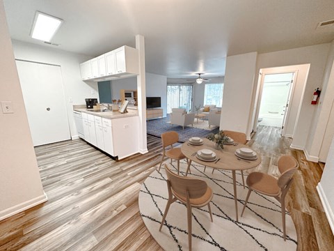 a kitchen and dining room with a table and chairs