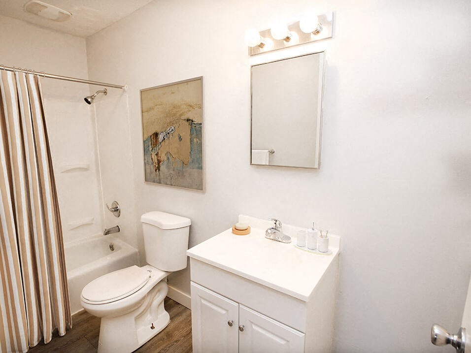a bathroom with a sink toilet and shower