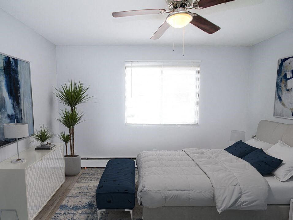 a bedroom with a bed and a ceiling fan