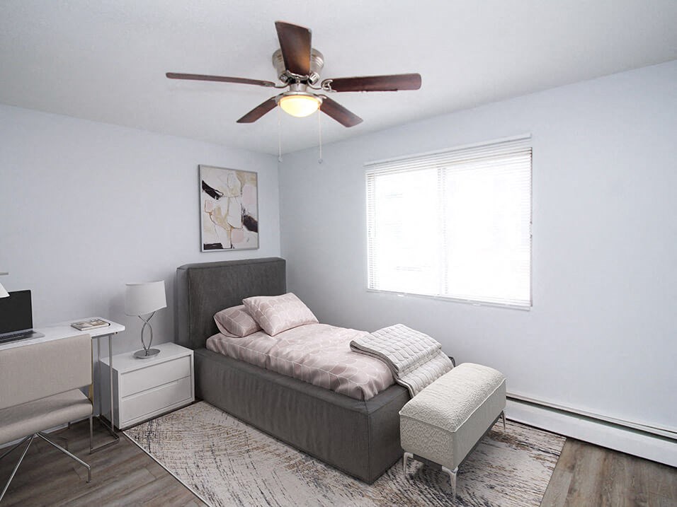 a bedroom with a bed and a ceiling fan