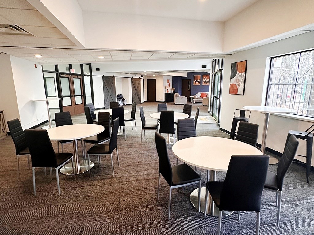 a large room with tables and chairs at eden park clubhouse