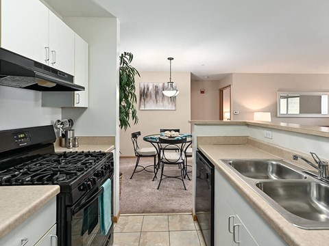 a kitchen with a stove and a sink and a table