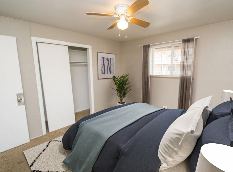 Bedroom with closet and window with overhead light and fan