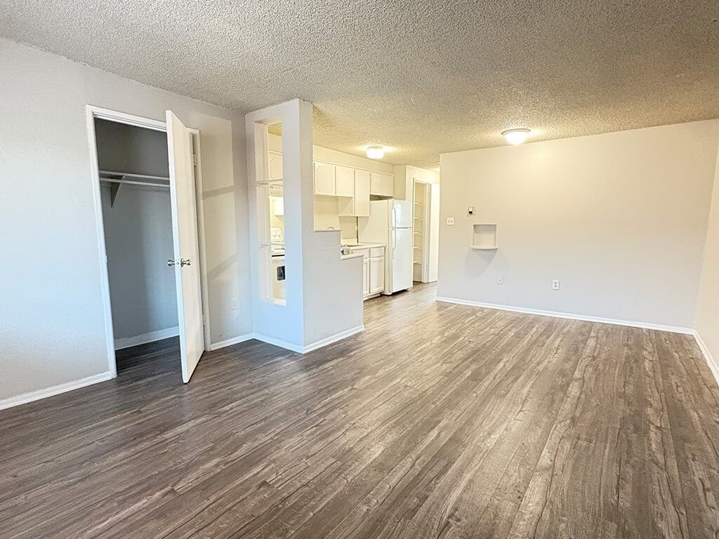A room with a wooden floor and white walls.