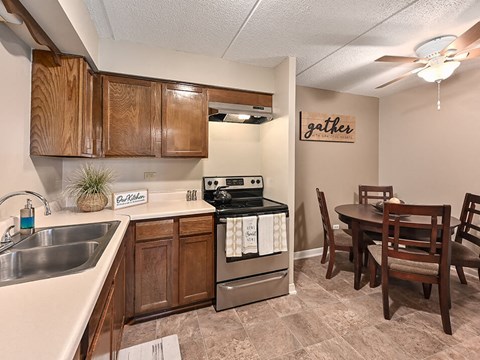 a kitchen with stainless steel appliances and a dining room table