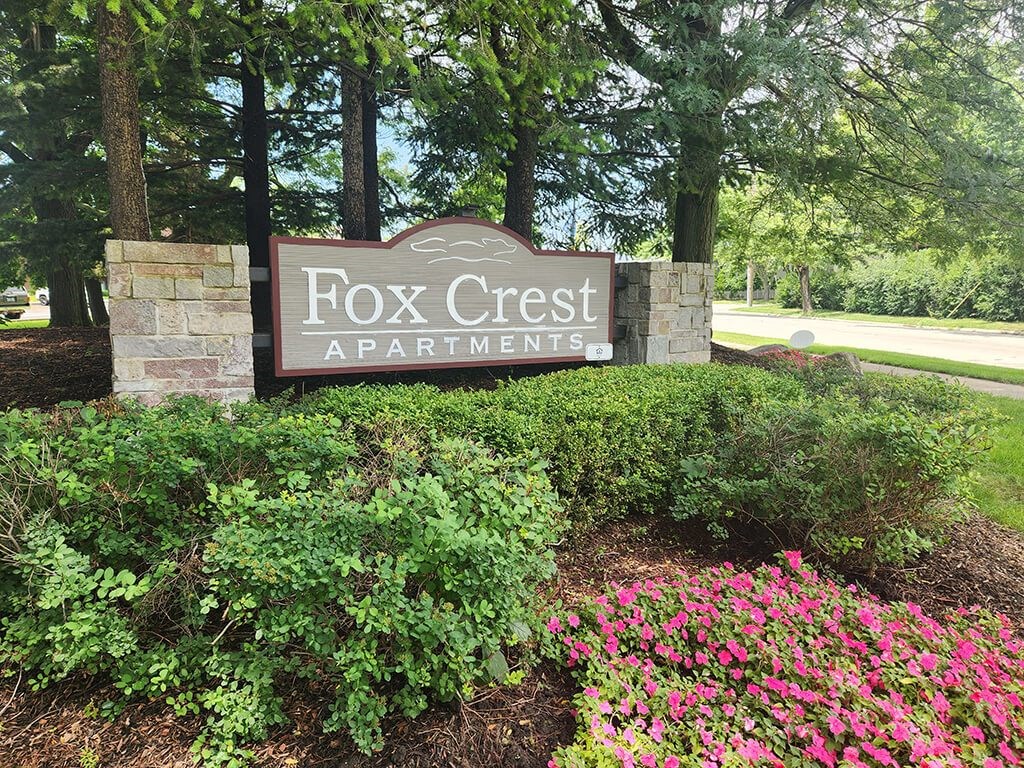 a welcome sign for Fox Crest Apartments