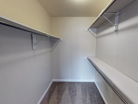 A storage room with shelves and a carpeted floor.