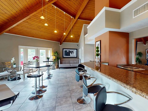 A modern living room with a bar area and a television.
