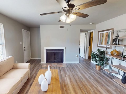 A living room with a fireplace and a white sofa.