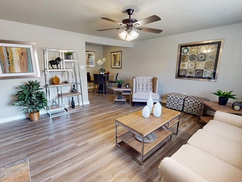 A living room with a white couch and a wooden coffee table.
