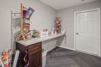 a room with a desk and a white door