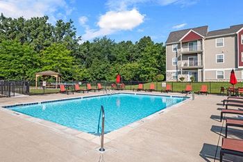 a swimming pool in front of an apartment building