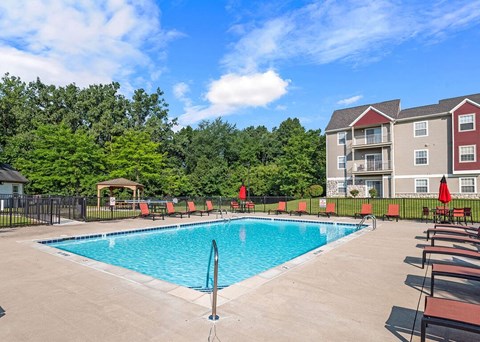 a swimming pool in front of an apartment building