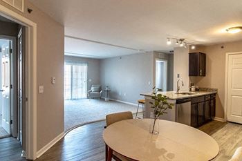 Dining area with kitchen and living areas in the background